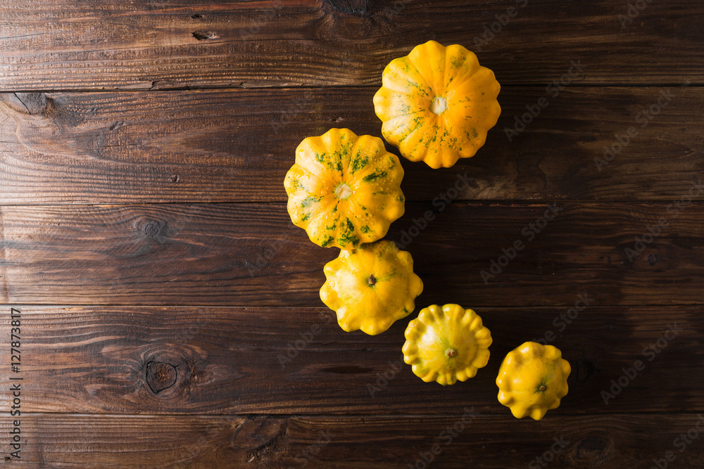 Yellow squash on a wooden background. Top view, Colorful festive still life. Copyspace. Yellow squash on a wooden background. Top view, Colorful festive still life. Copyspace.