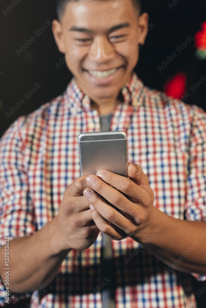 Handsome young man using his mobile. Handsome young man using his mobile.