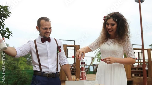 Couple laughing on the background of the wedding decorations. The sand mix.