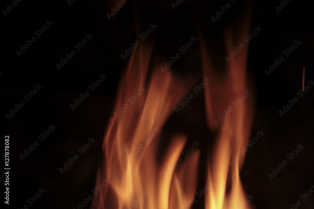 Flames of fire in a fireplace. Shooting horizontal with tones Orange and black. Flames of fire in a fireplace. Shooting horizontal with tones Orange and black.