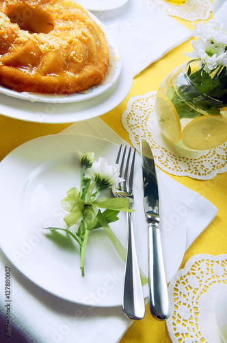 Yellow summer table setting with lemon bundt cake