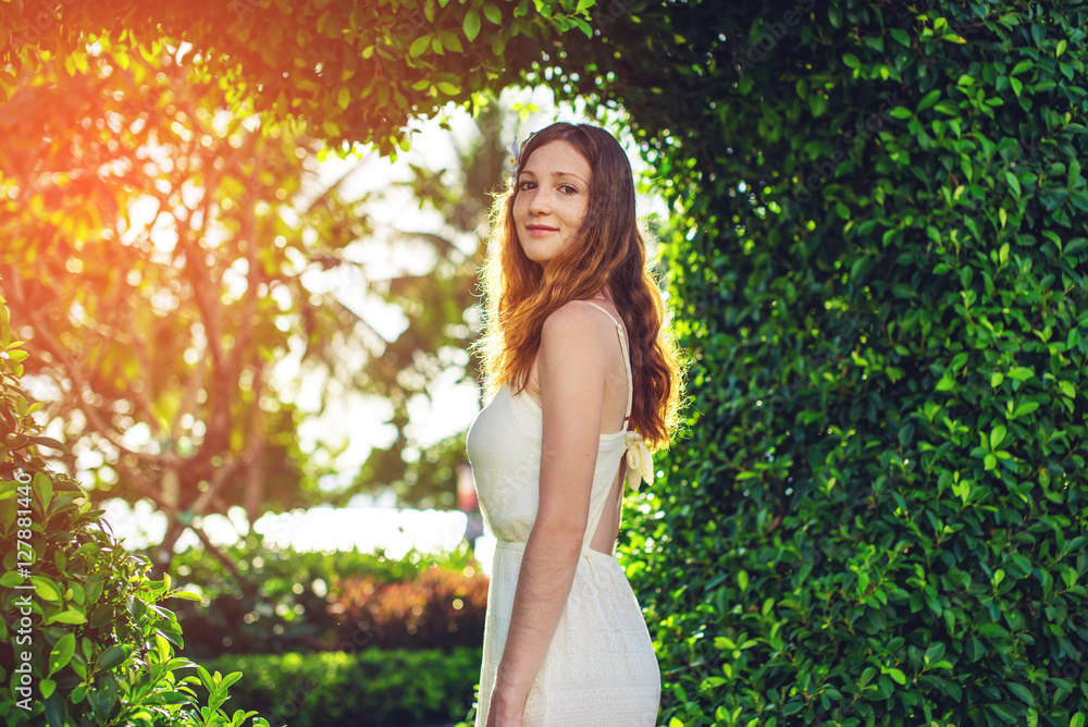 woman standing on background of green bushes shape like heart woman standing on background of green bushes shape like heart