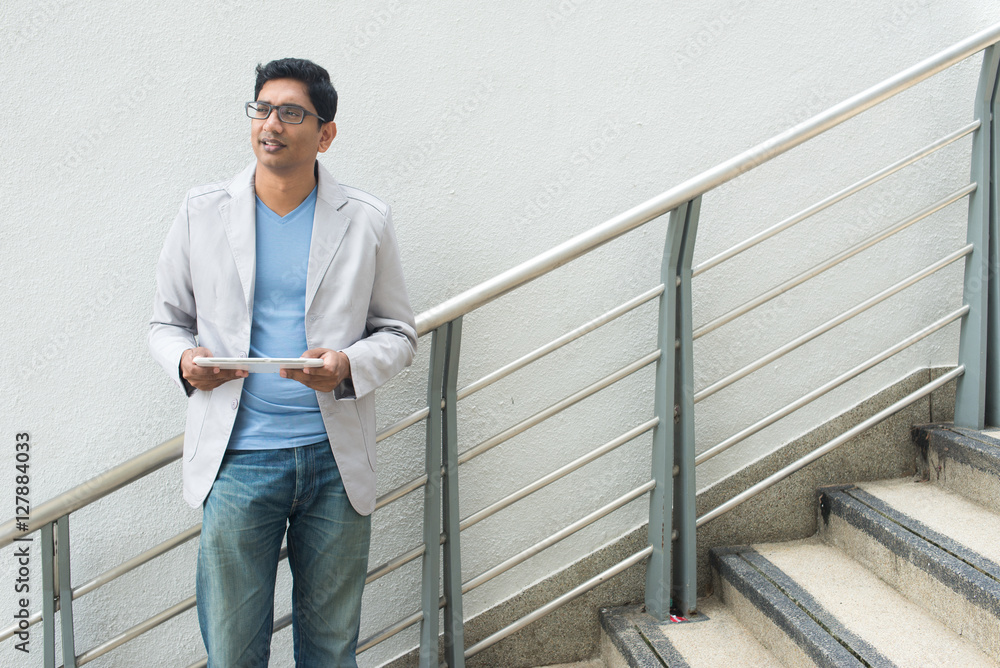 indian male using tablet indian male using tablet
