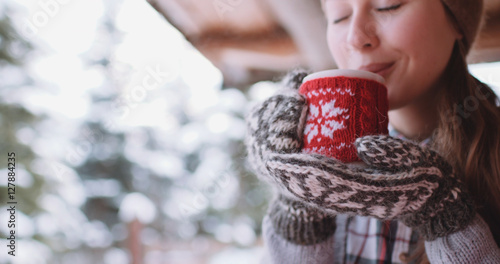 Woman Drinks Hot Tea or Coffee From a Cozy Cup on Snowy Winter M