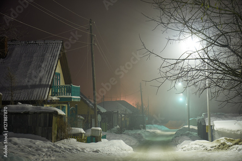 Night shot of country street under snow in winter season