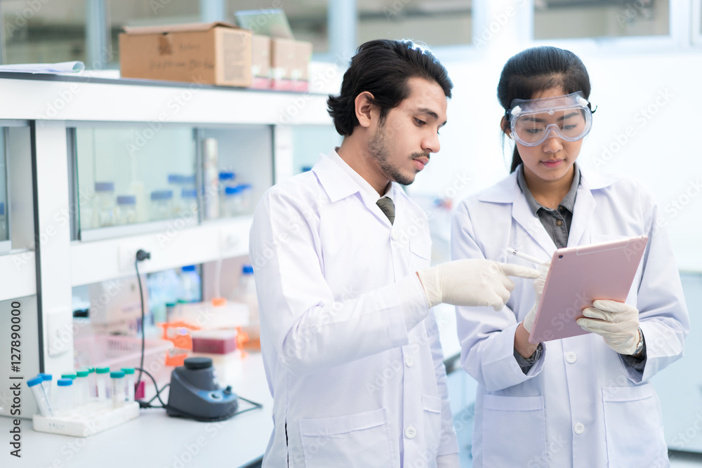 Scientists asian in the laboratory they use a tablet recording t Scientists asian in the laboratory they use a tablet recording t