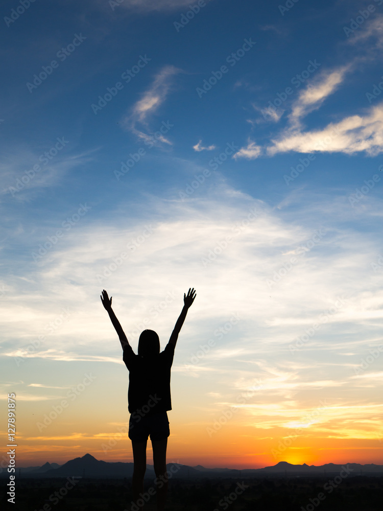 Young woman enjoying outdoors, sky background,sunset