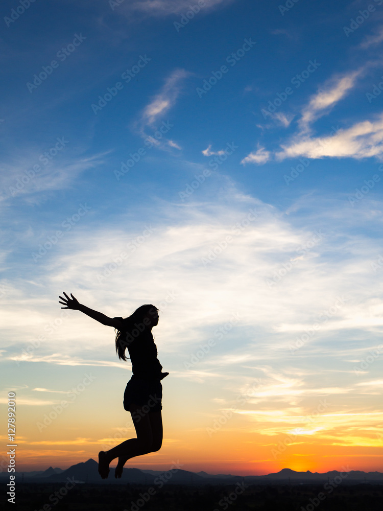 Young woman enjoying outdoors, sky background,sunset