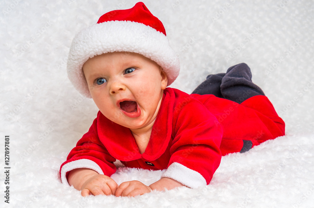 Cute newborn baby with Santa costume yawning Cute newborn baby with Santa costume yawning
