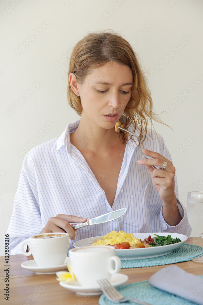 Girl having breakfast and a cup of coffee