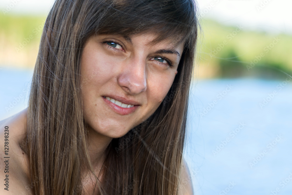 Portrait of a young beautiful girl with a smile and with dark hair