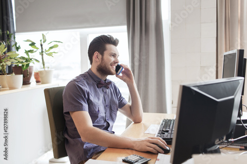 happy creative male worker calling on smarphone