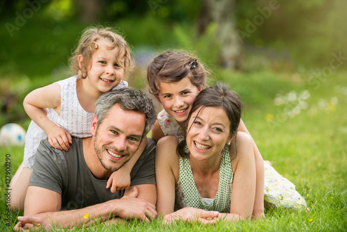 Summertime. happy family lying on the grass in a park