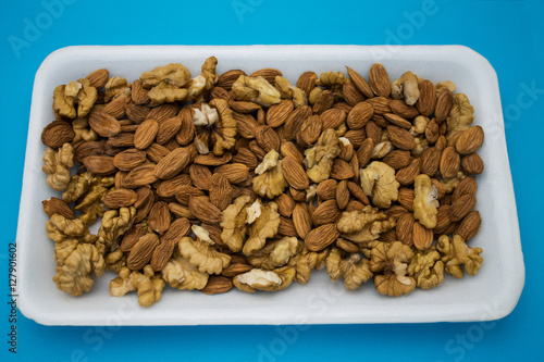 apricot stones and walnuts in blue background