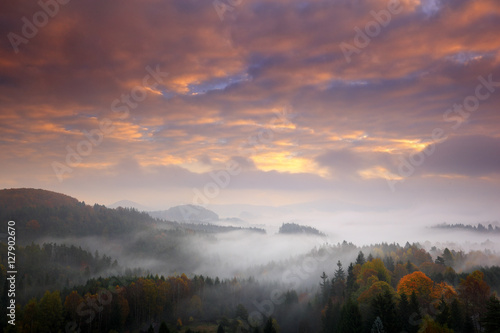 Czech typical autumn landscape. Hills and forest with foggy morning. Morning fall valley of Bohemian Switzerland park. Hills with fog, landscape of Czech Republic, Ceske Svycarsko, wild Europe.