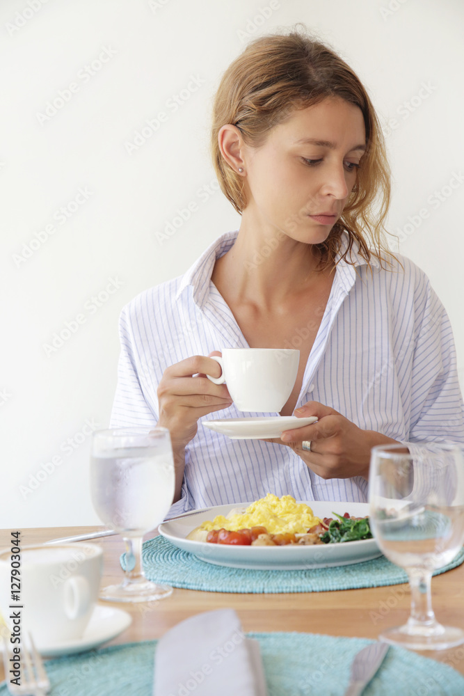 Girl having breakfast and a cup of coffee