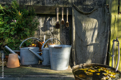 romantic idyllic plant table in the garden with old retro flower pot pots, tools and plants © esben468635