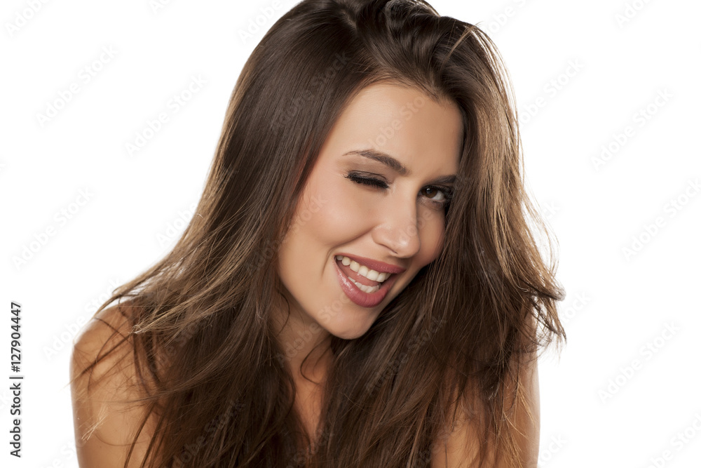 Young happy woman winking on a white background Young happy woman winking on a white background