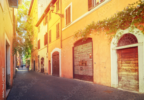 Fototapeta Naklejka Na Ścianę i Meble -  old town italian street in Trastevere with sunshine, Rome, Italy