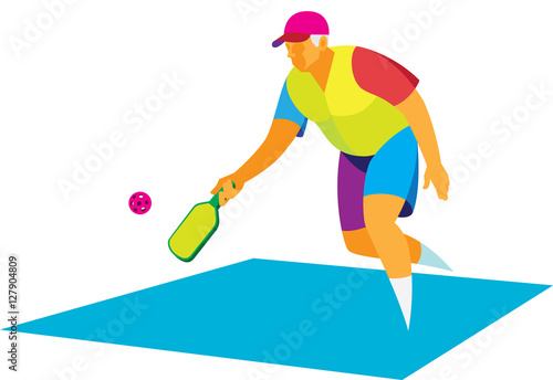 Energetic elderly man playing on a court with a racket and ball