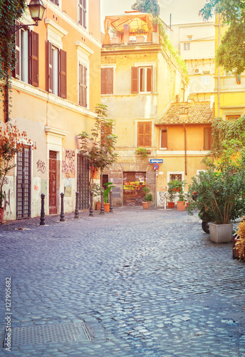 Fototapeta Naklejka Na Ścianę i Meble -  typical italian street in Trastevere with sunshine, Rome, Italy