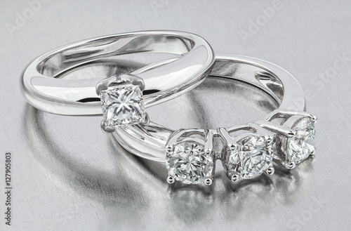 Diamond ring. Two diamond rings. Golden wedding rings. Bride rings with diamonds.