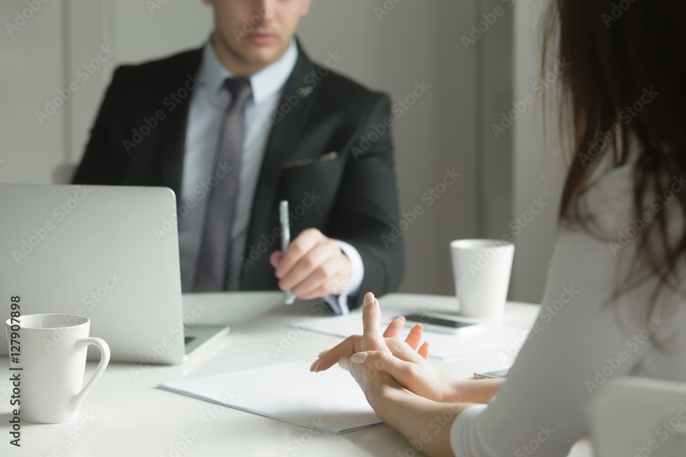 Close up of business people hands hold at an office desk, young man and woman are having a business talk. The woman feels stressed. Business concept photo Close up of business people hands hold at an office desk, young man and woman are having a business talk. The woman feels stressed. Business concept photo