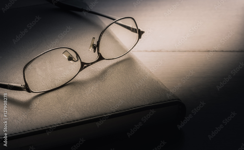 Place the glasses on the notebook. The concept of the idea. Place the glasses on the notebook. The concept of the idea.