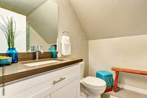 Attic bathroom interior with new vanity cabinet