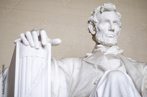 Statue of American president Abraham Lincoln seated in white marble at the Lincoln Memorial in Washington DC, USA 