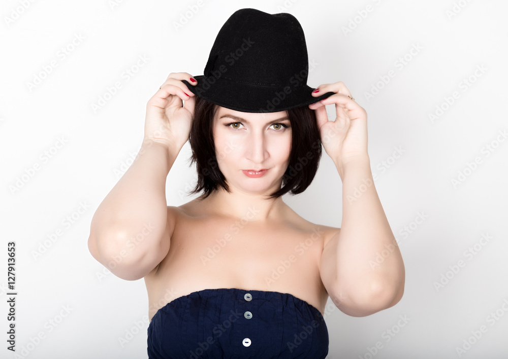 Closeup portrait of beautiful sexy young woman in black hat, posing Closeup portrait of beautiful sexy young woman in black hat, posing