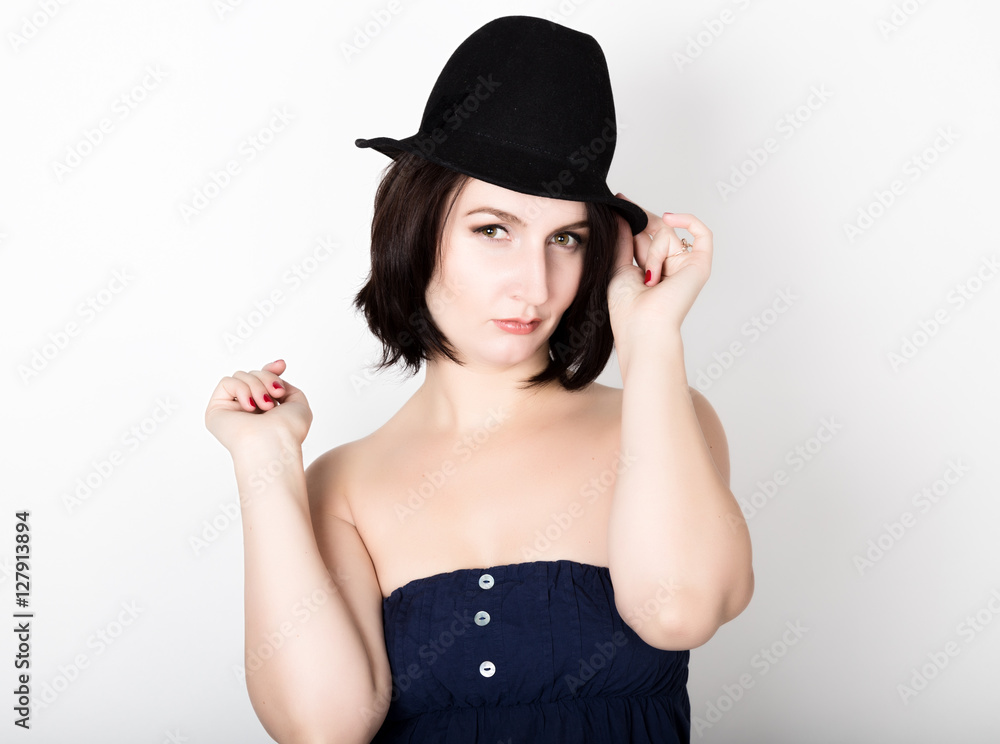 Closeup portrait of beautiful sexy young woman in black hat, posing Closeup portrait of beautiful sexy young woman in black hat, posing