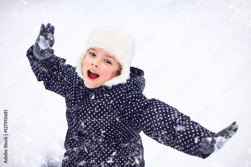 Portrait of a cute little girl in the snowy park. Portrait of a cute little girl in the snowy park.
