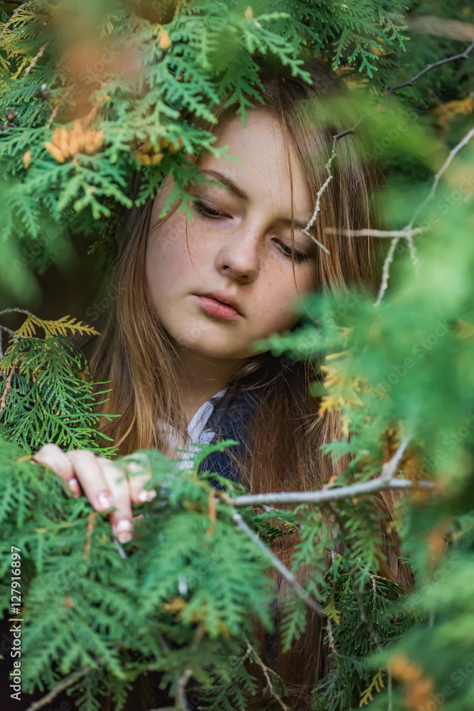Portrait of a girl in the branches of a cypress Portrait of a girl in the branches of a cypress