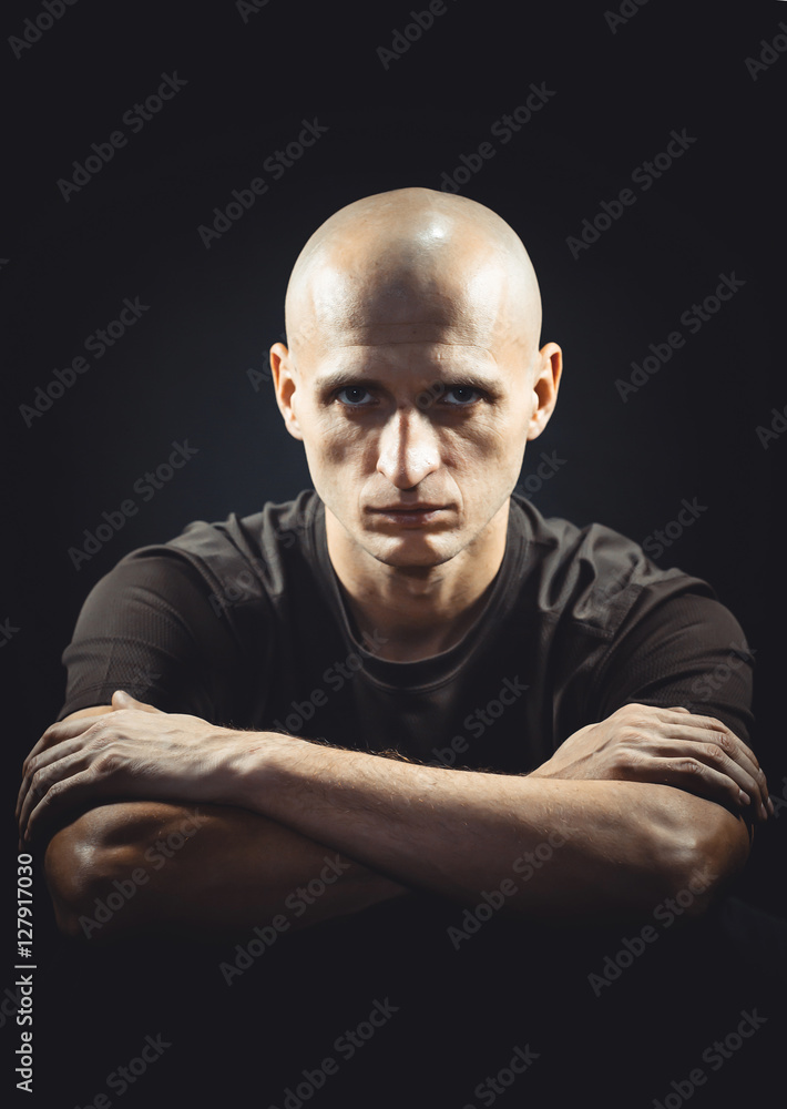 Portrait of a bald shaven men on a black background Portrait of a bald shaven men on a black background