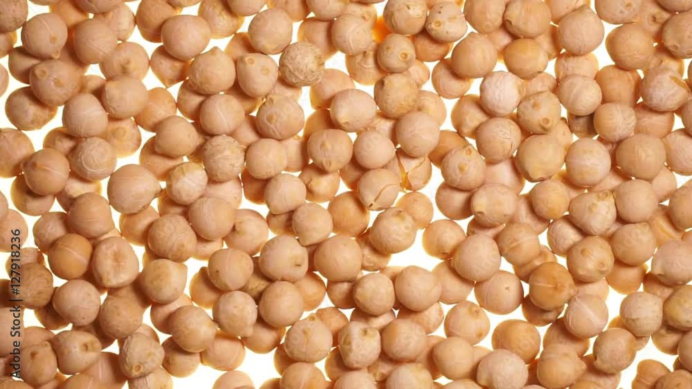 Falling chickpeas on a white background fills the screen. Falling chickpeas on a white background fills the screen.