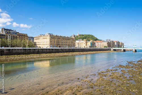 View over the river Urumea to the Victoria Eugenia Theater, a neoplateresque building, a special Spanish architecture, in Donostia San Sebastian. The river is passing through the very nice Basque city