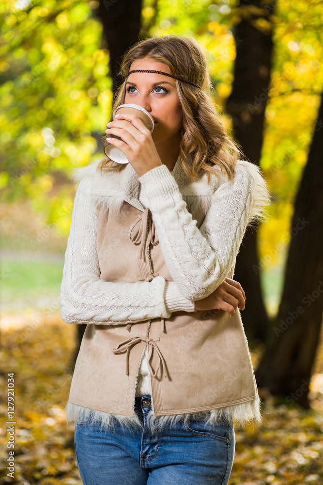 Beautiful boho girl enjoys drinking coffee in the park. Beautiful boho girl enjoys drinking coffee in the park.