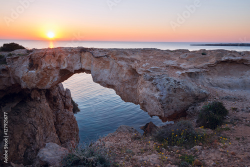 Sun rises over the stone natural bridge © sanechka