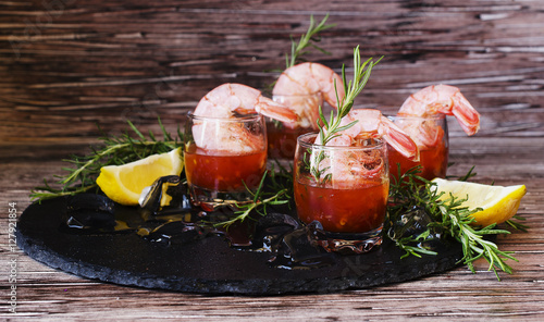 appetizer of shrimp cocktail with rosemary and sauce, selective focus