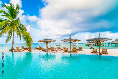 Swimming pool bar in tropical Maldives island .