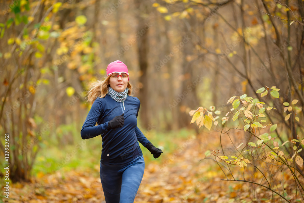 Woman runner in the morning autumn park Woman runner in the morning autumn park