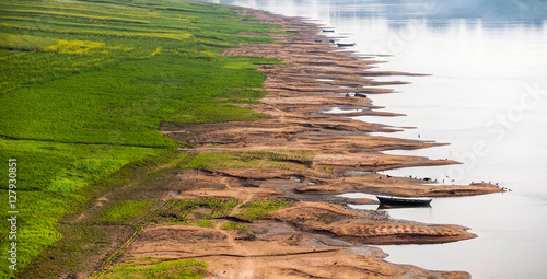 Soil erosion banks of the Ganges River. Crops of agricultures in the delta of the river are penetrated by net of gullies. Destruction of the coast is caused by tropical rains.