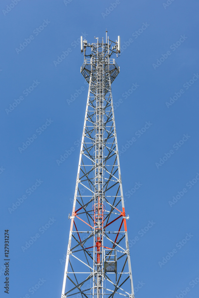 The top of communications tower with blue sky background. The top of communications tower with blue sky background.