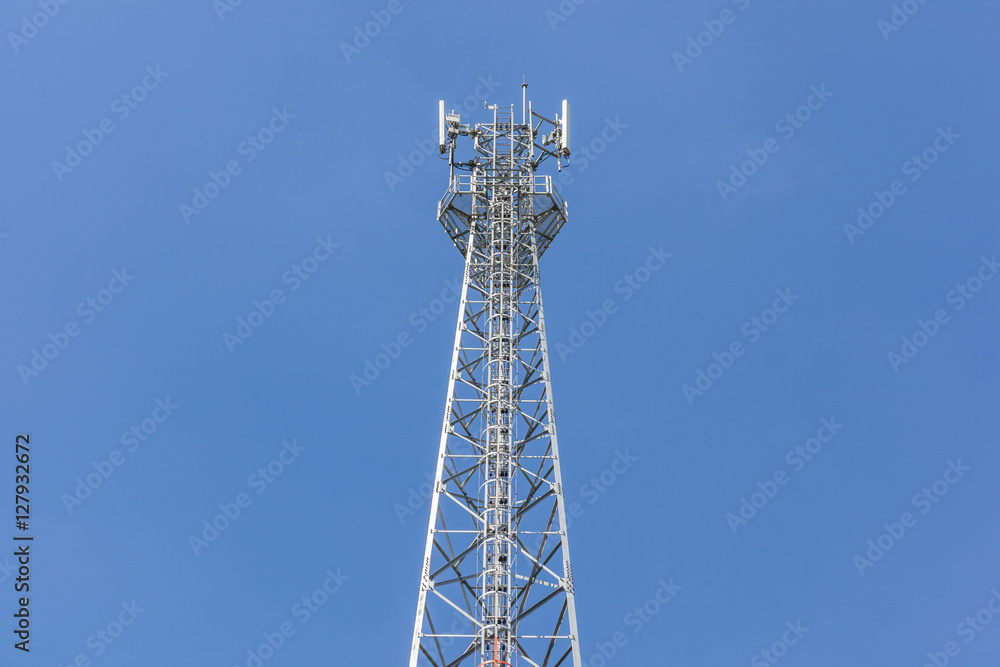 The top of communications tower with blue sky background. The top of communications tower with blue sky background.