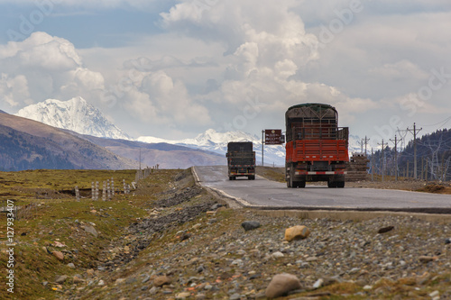 Truck on the road in Tibet under snow mountain