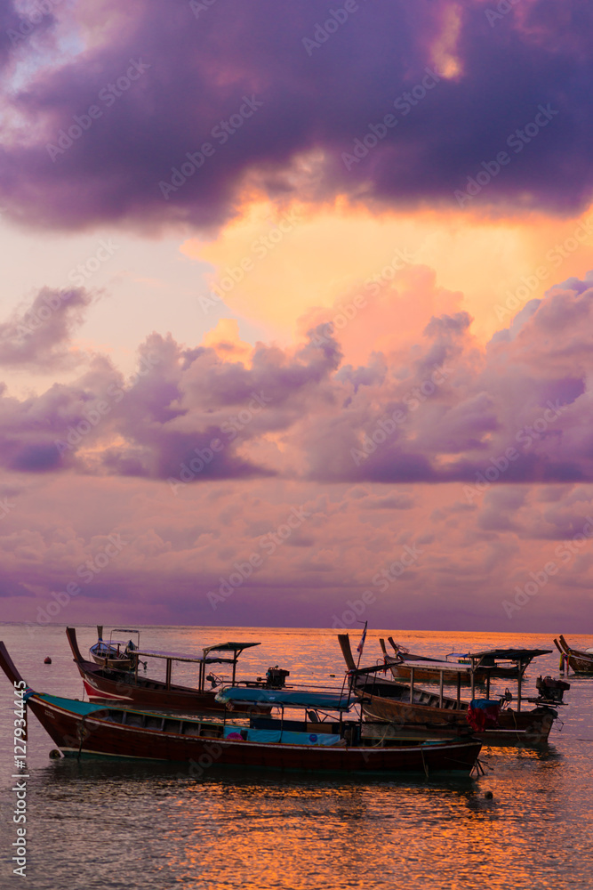Wooden fisherman boat with sky background on sunrise