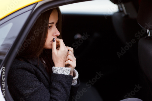 Beautiful girl sitting in car © snedorez