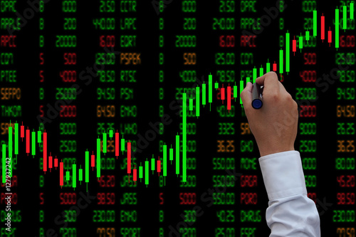 Businessman hand touching Candlestick Chart, investment concept