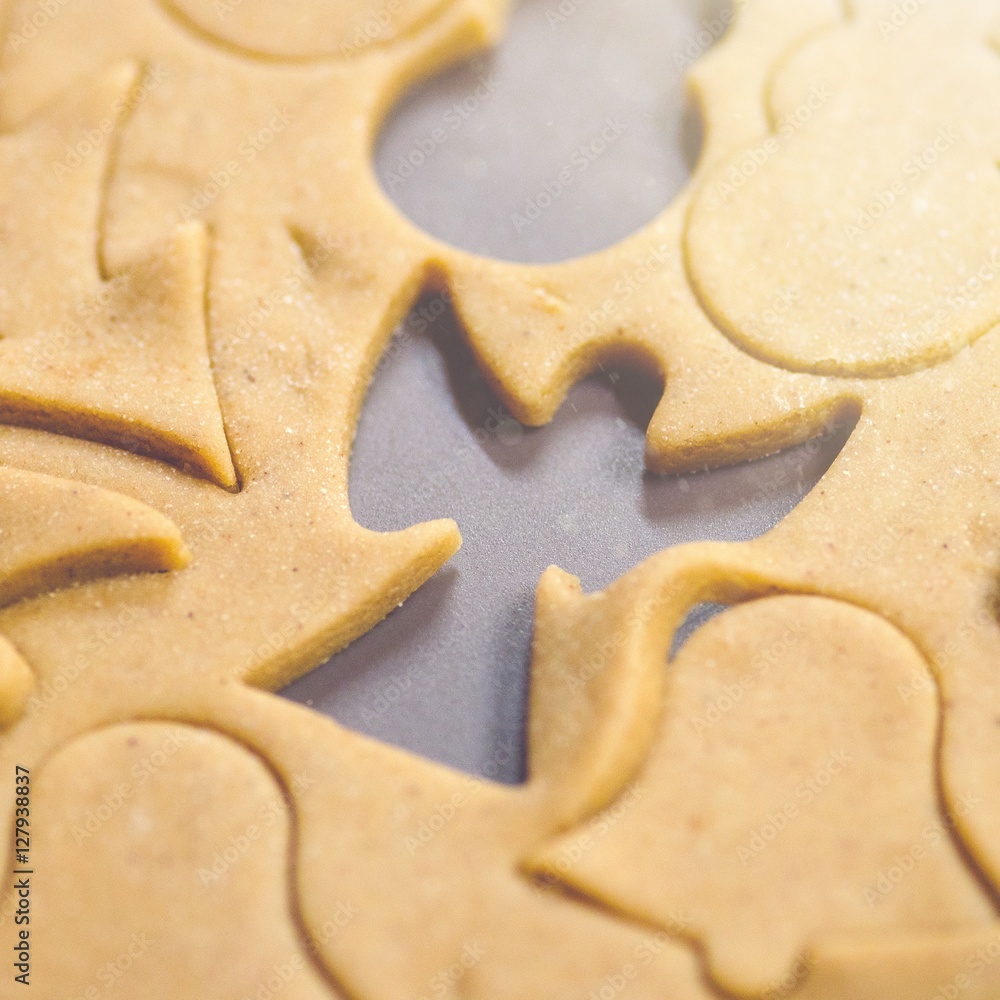 Abstract Christmas food background with cookies molds and flour. Baking Christmas cookies - table, cookie cutters and cookies. Abstract Christmas food background with cookies molds and flour. Baking Christmas cookies - table, cookie cutters and cookies.